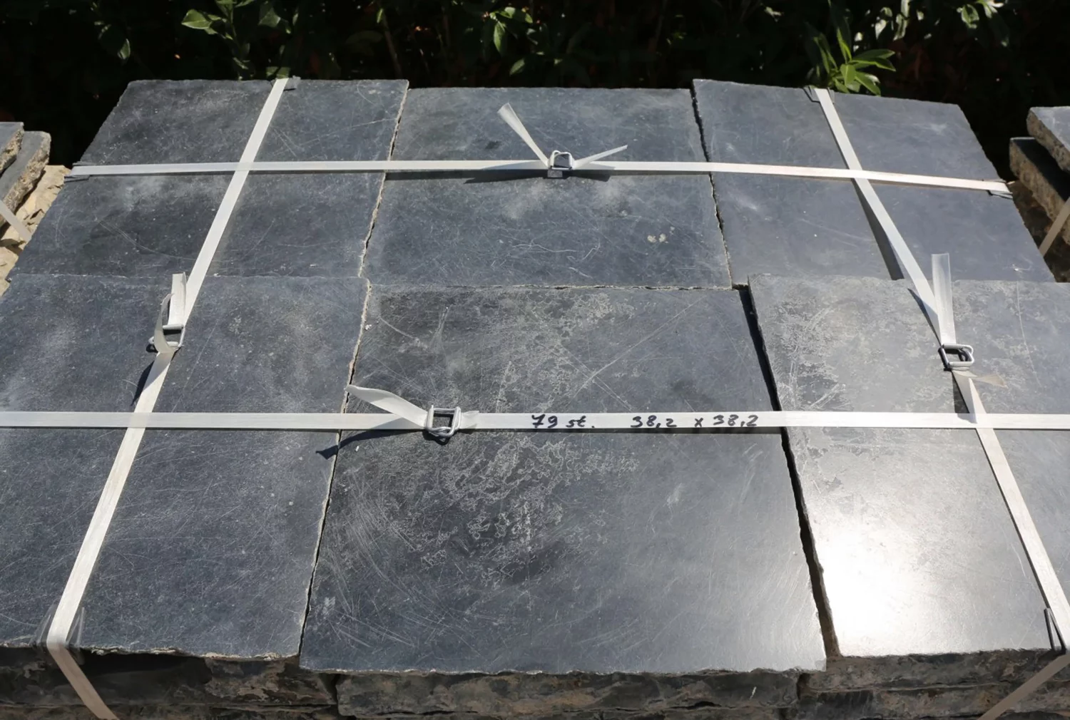 Large-format 47x47 cm Noir de Mazy church floor tiles in an entrance hall