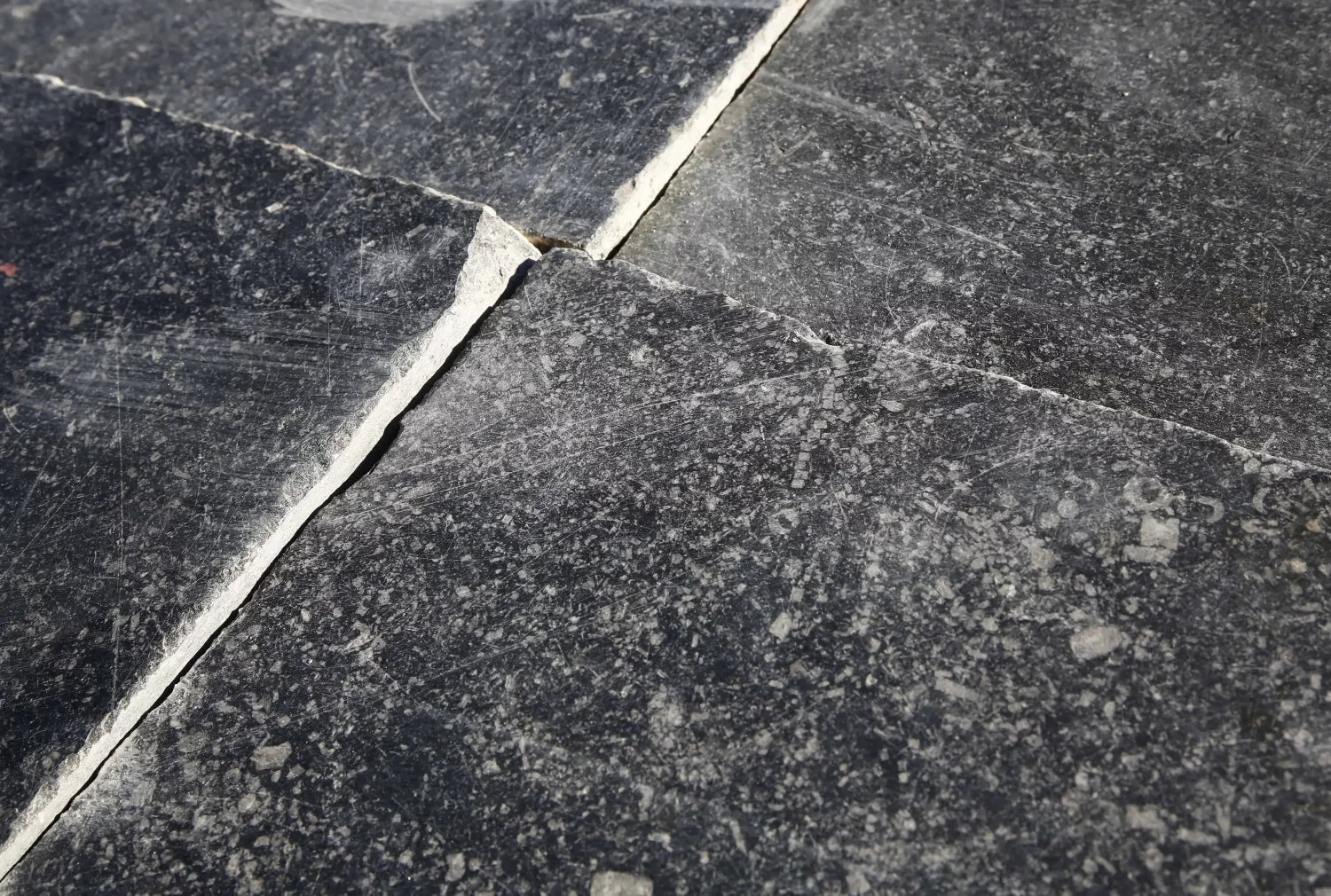 Close-up of first choice reclaimed Belgian black limestone tile – 44x44 cm, calibrated to 2.5 cm, with natural patina