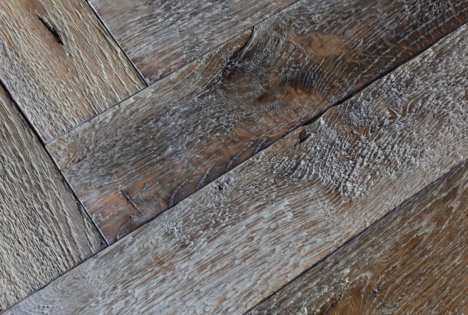Close-up of subtly aged Le Marais oak herringbone parquet, pre-coloured and protected