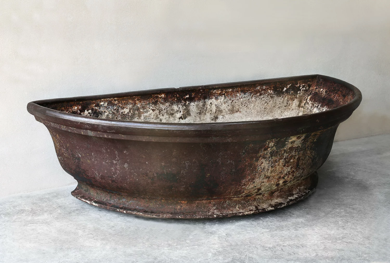 Side view of antique cast-iron trough, circa 1880-1920 (late 19th century), showing depth and proportions