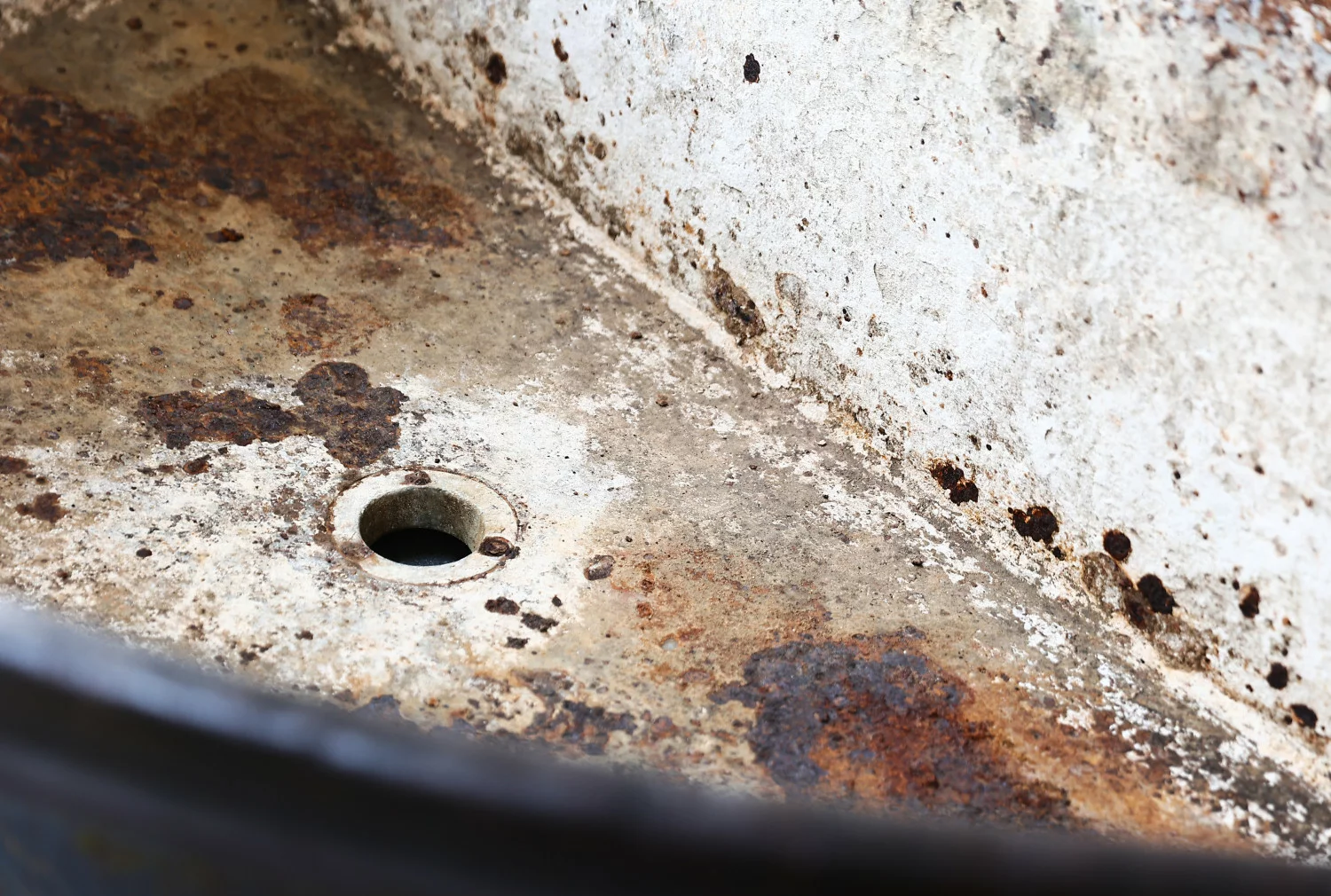Inside view of antique cast-iron trough, circa 1880-1920, showing historic surface character and original drainhole