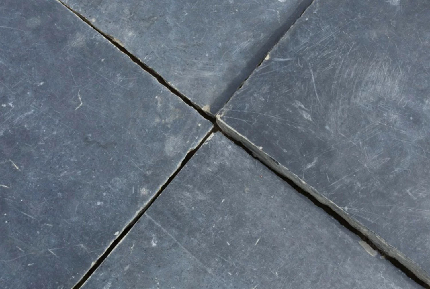 Pallet with sorted antique Noir de Mazy church floor tiles in the De Opkamer warehouse