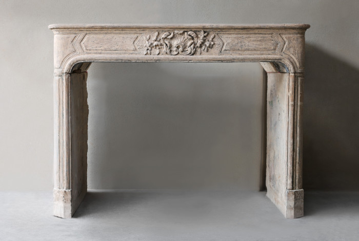 Antique fireplace of French limestone