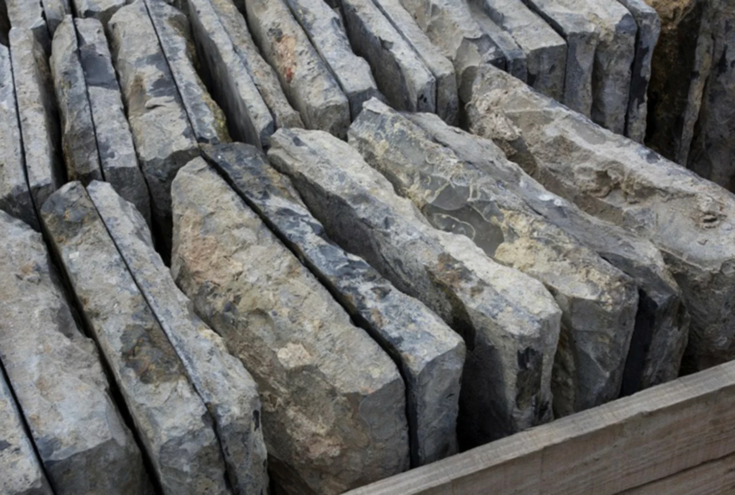 Detail of hand-cut edge and aged patina on antique Belgian black limestone church tile