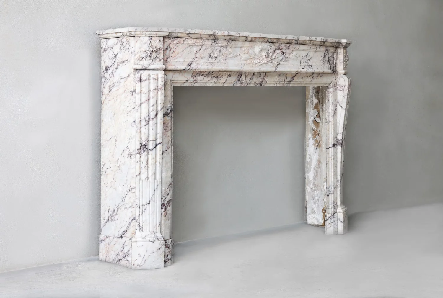 Angled view of Escalette marble chimneypiece showing bowed shelf and profiles, Louis XVI style, Ref. 1581