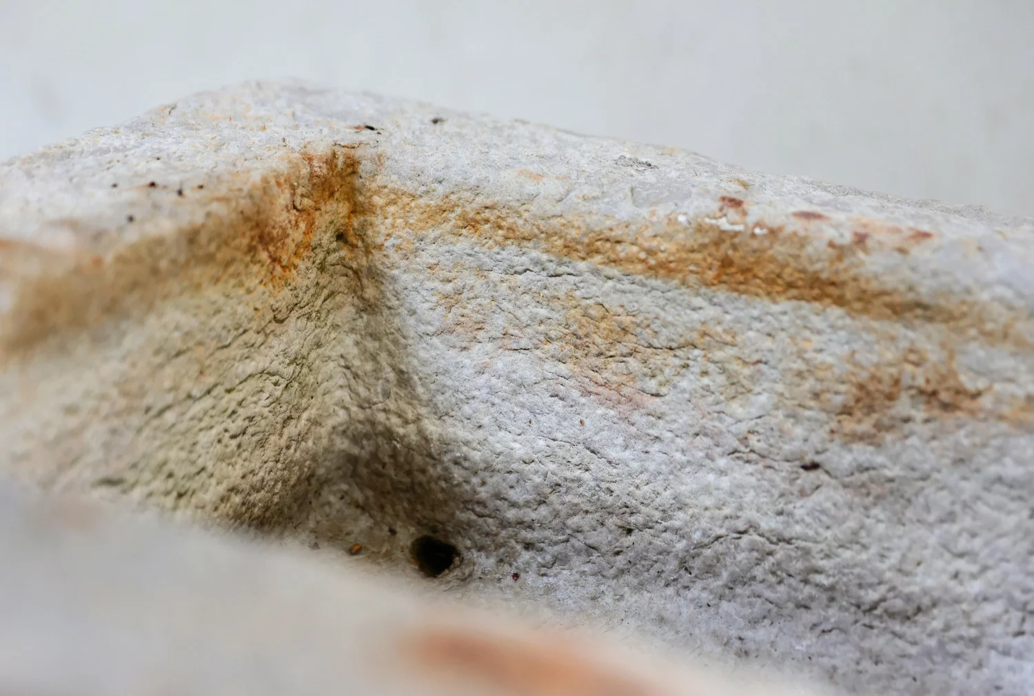 old wash basin of burgundy stone