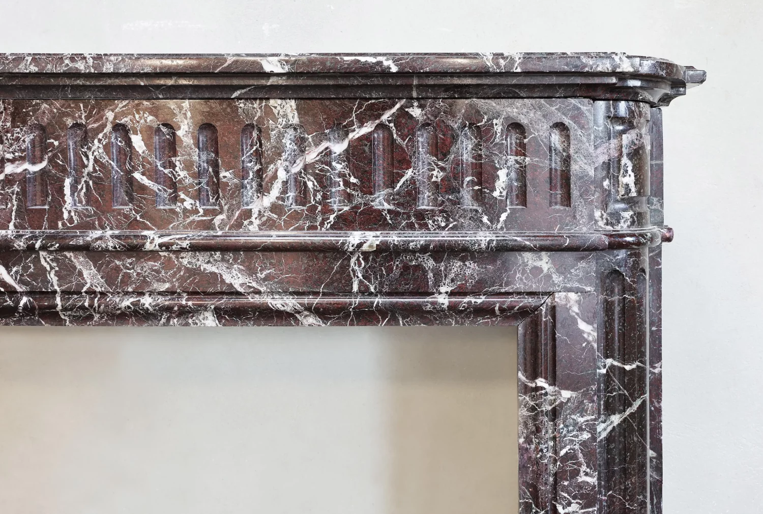 Right corner detail of broad frieze and profiles on vintage mantel, Rouge Levanto marble, Ref. 1172