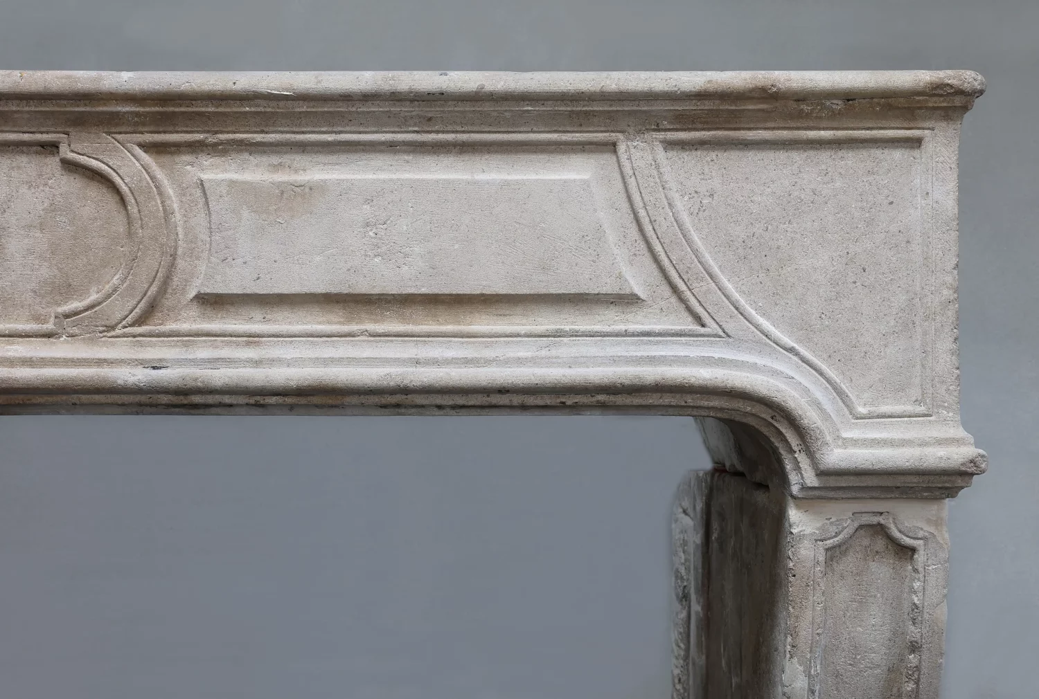 Right corner detail of Antique French Fireplace Ref. 1578 showing aged patina, wear, and traces of use in French limestone.