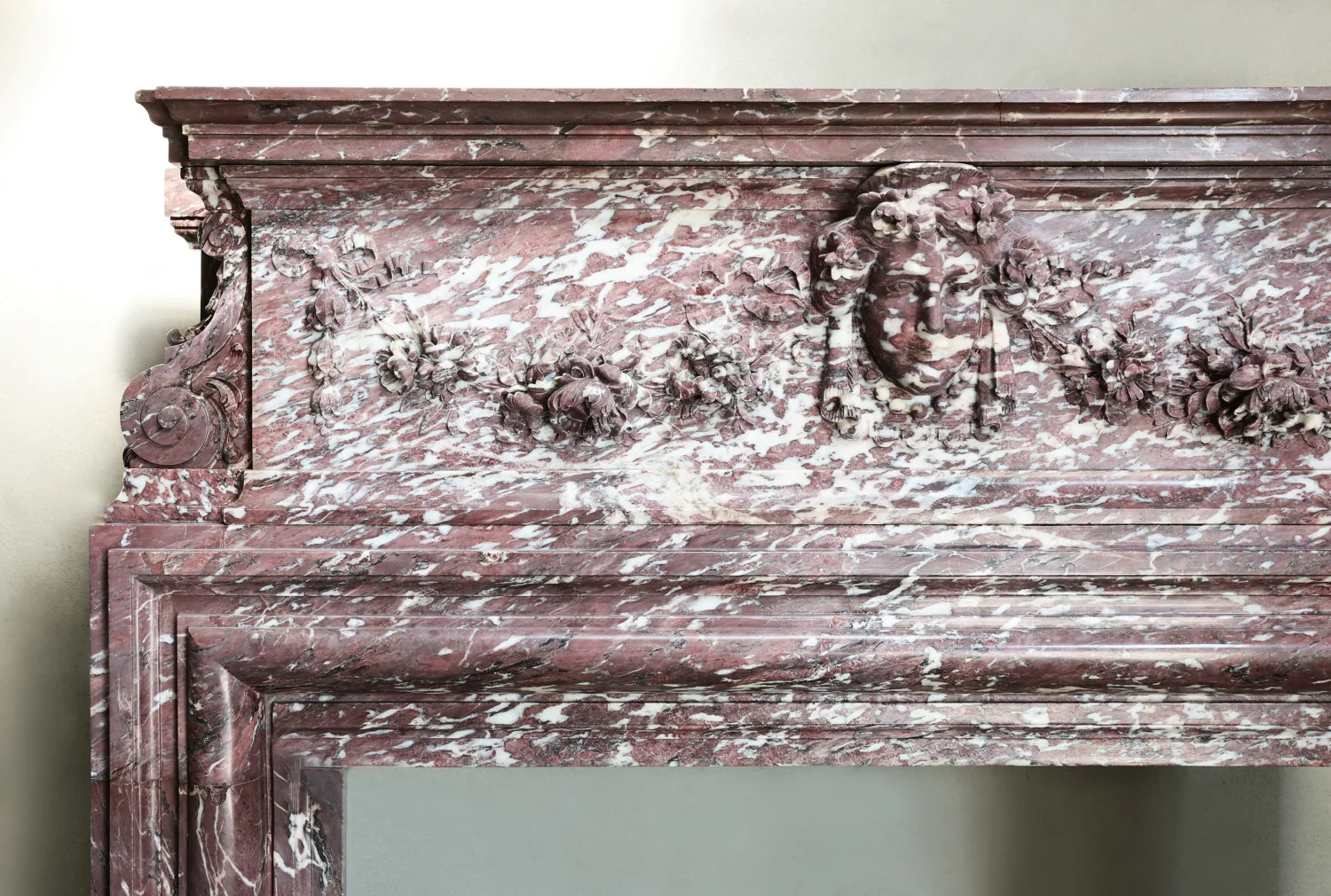 Right side of antique Fleur de Pêcher marble fireplace mantel showing scroll console and moulded jamb