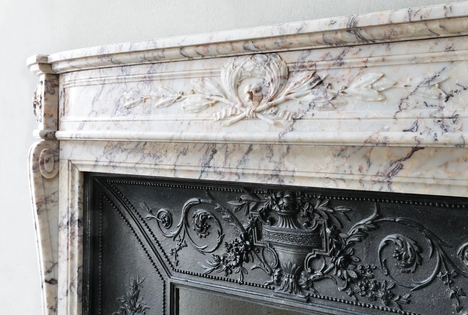 Angled detail view of lintel cartouche carving and contrasting veining, antique surround, Ref. 1581