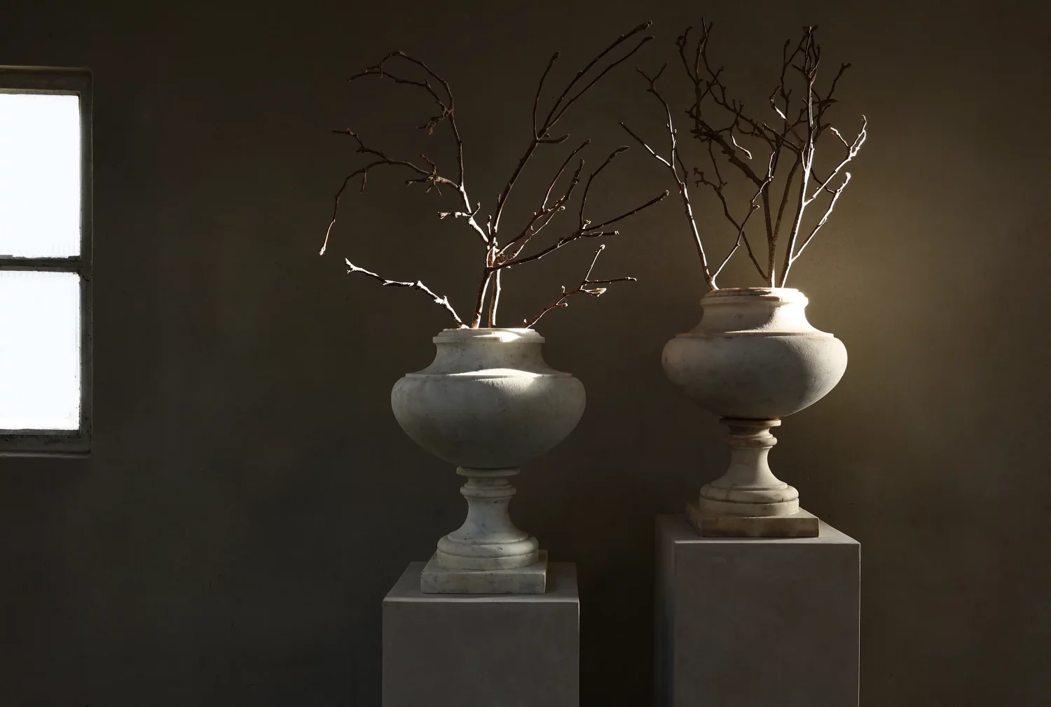 Pair of antique white marble urns, neoclassical silhouette on plinth bases, frontal view, Ref. ID100